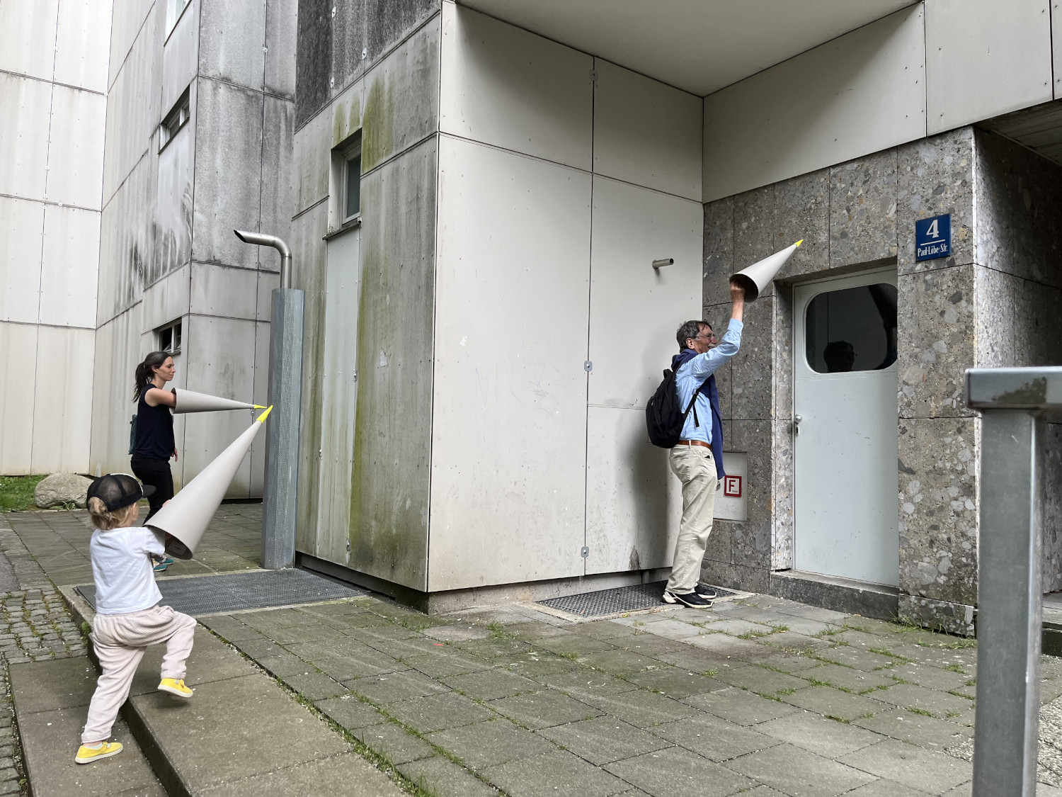 FAmily with paper cone hand in urban landscape
